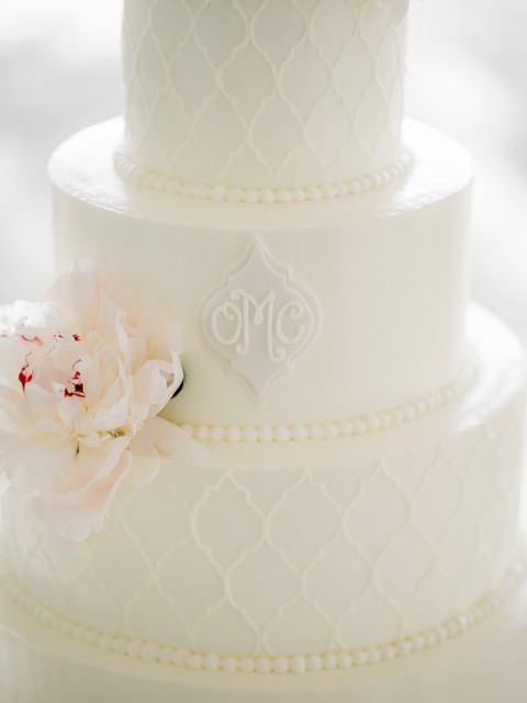 Tiered wedding cake with a custom monogram detail