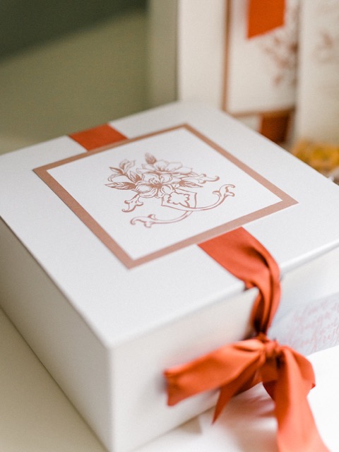 Custom welcome box tied with a tailored ribbon and crest