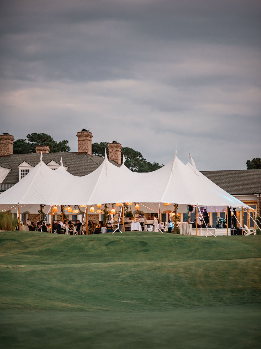 Sailcloth tent reception at dusk on the water