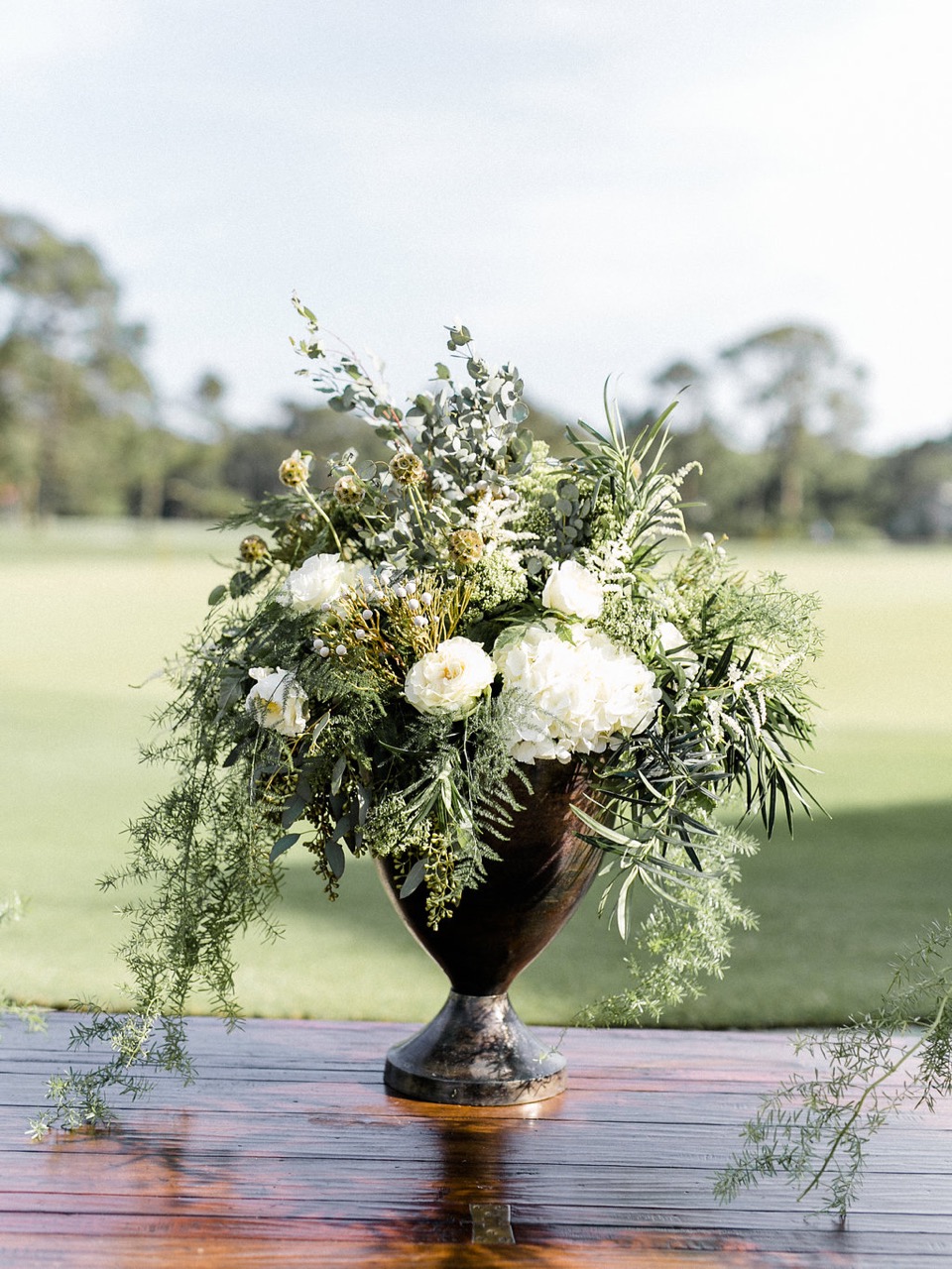 Reception seating dressed with greenery and gold, Lowcountry wedding